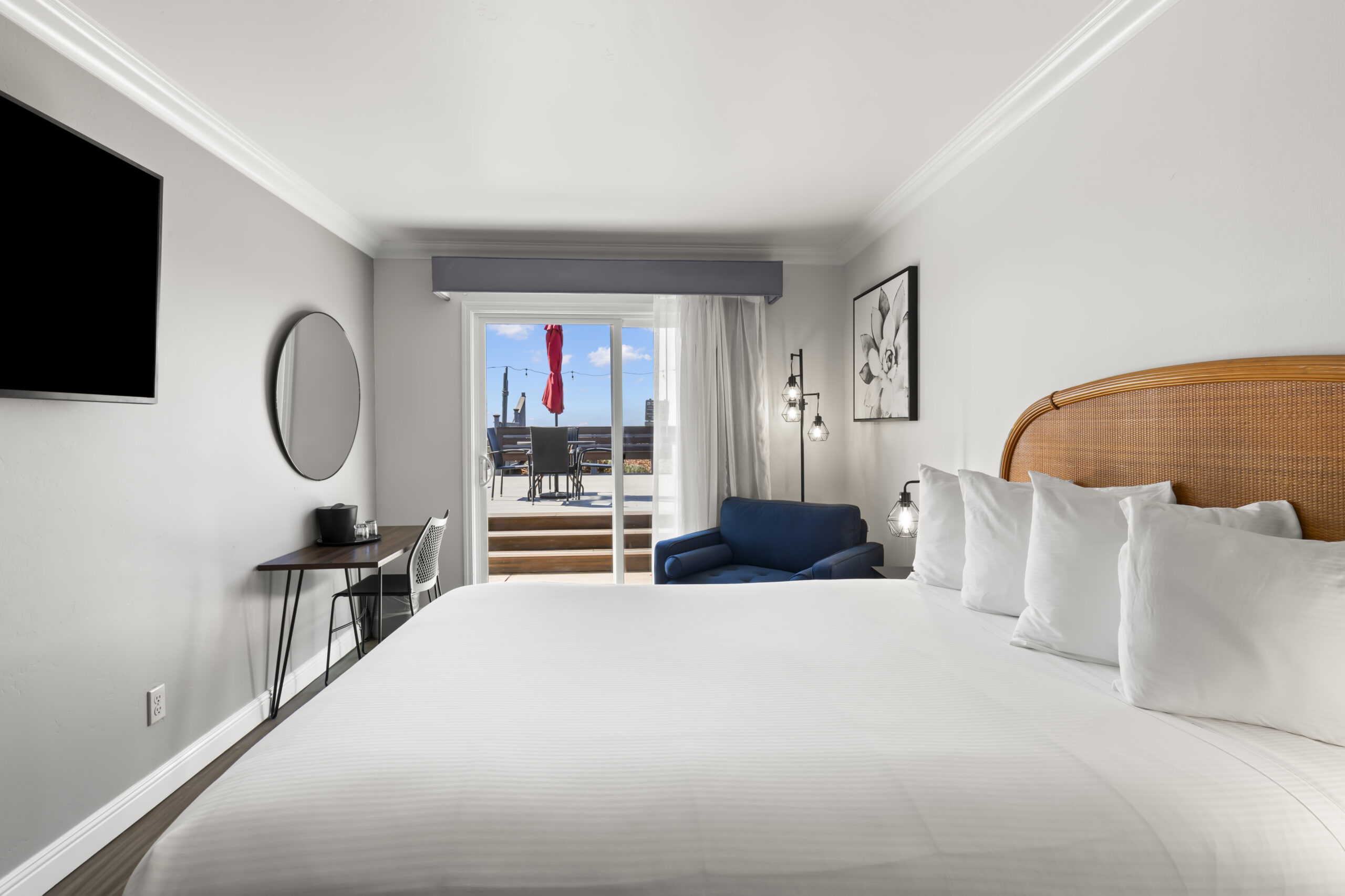 Step out onto the BBQ and picnic deck with a more distant view of the ocean. Tables, umbrellas and chairs to sit and relax.